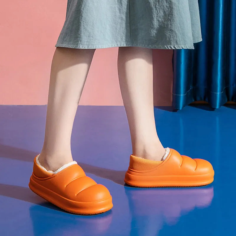 Women's winter slippers in green with plush lining and textured EVA sole, shown as sleeve-style overshoes.
