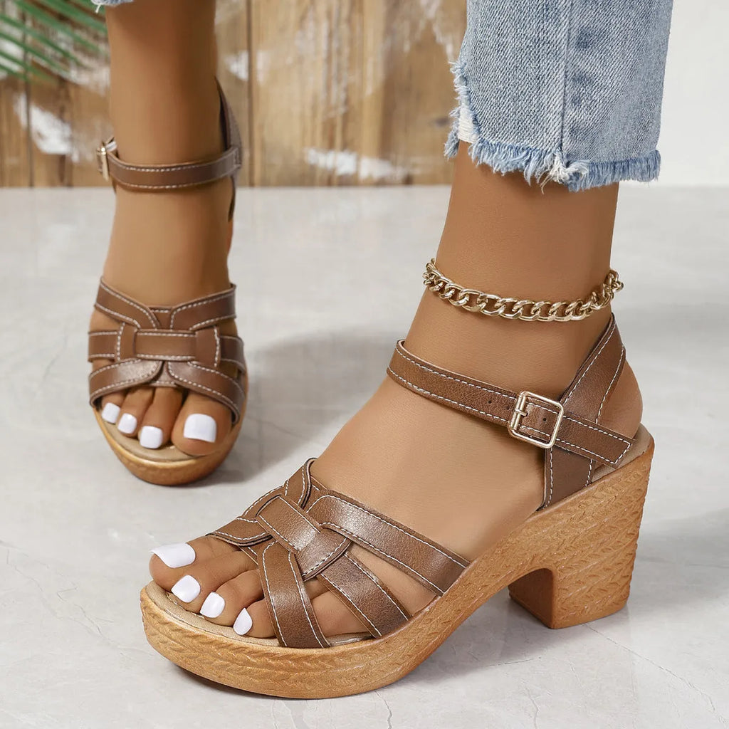 Plus size black peep toe high heel sandals with a chunky heel and ankle strap buckle on a white background.