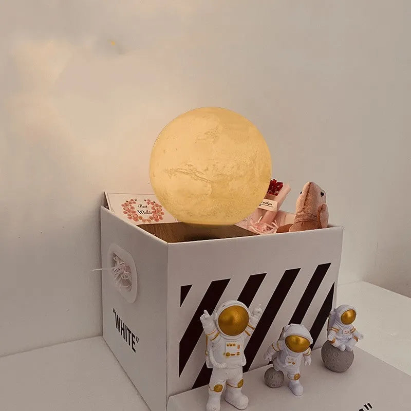 Maglev moon and planet night light floating above base with three astronaut figurines