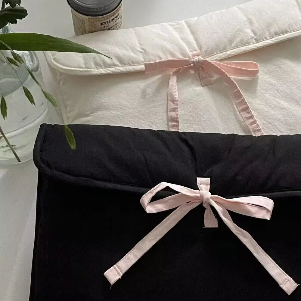 Black and white women's quilted nylon laptop bag with ballet bow in two size options.