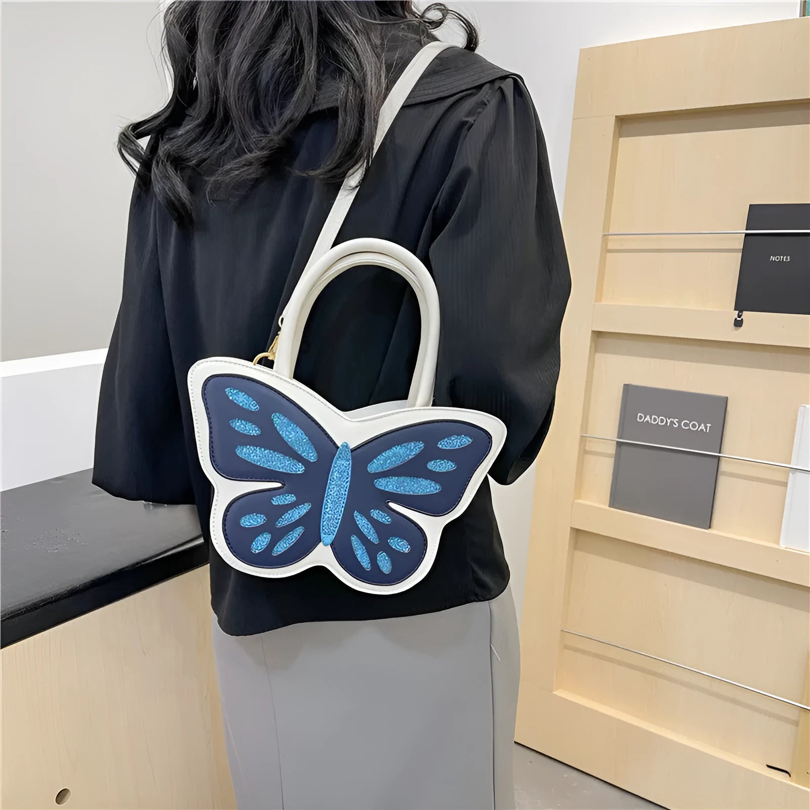 A white square crossbody bag for women with contrast colour details, showing its compact size and casual style.