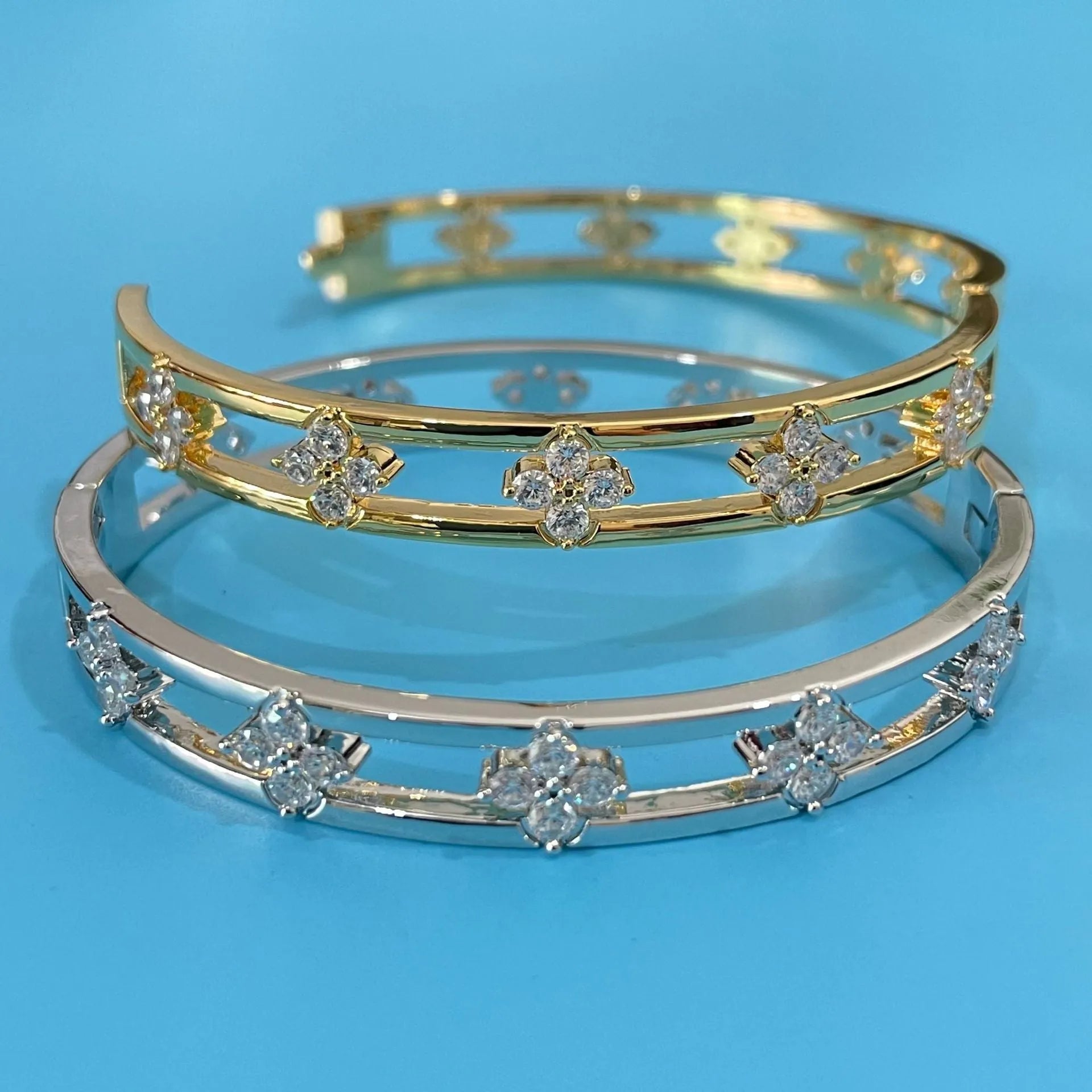 Hollow women's bracelet with four-leaf clover charm containing inlaid AAA zircon gemstones