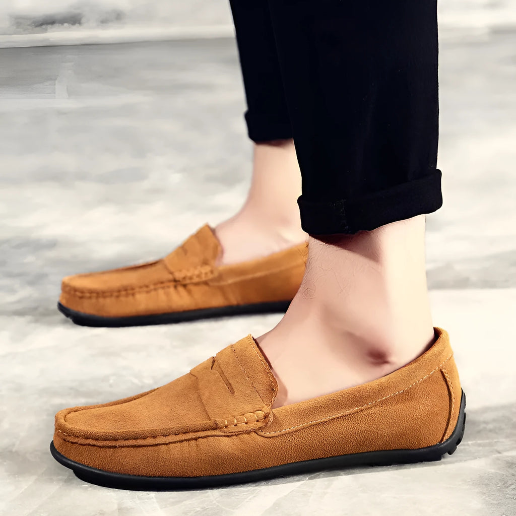 Men's brown suede Gommino casual loafers with a round toe and flat rubber sole.