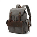 Retro canvas backpack in military green with antique bronze hardware showing front compartment organisation