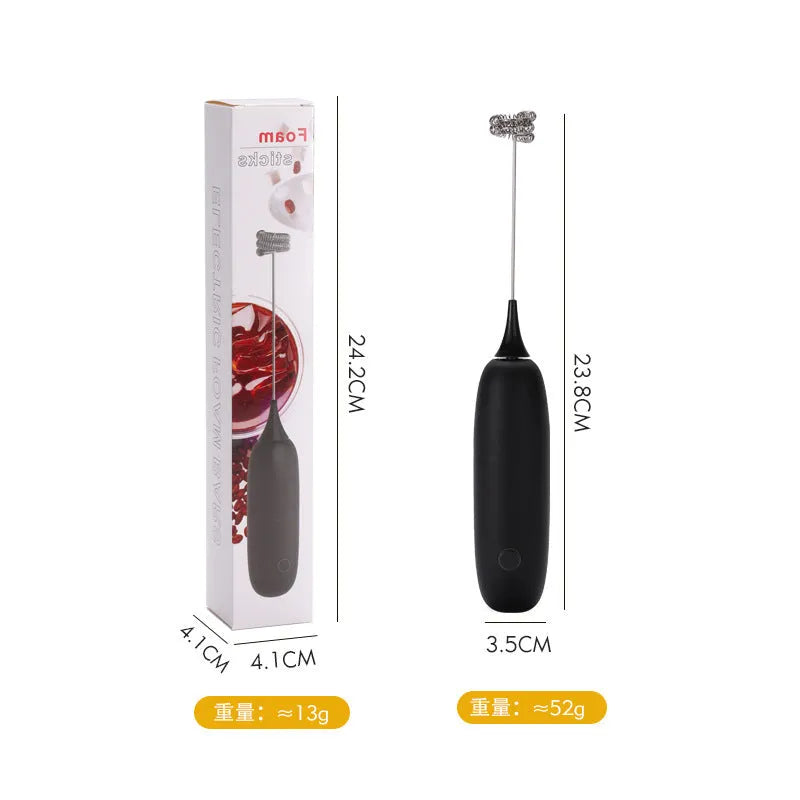 A handheld electric milk frother in black and white colours on a kitchen counter.