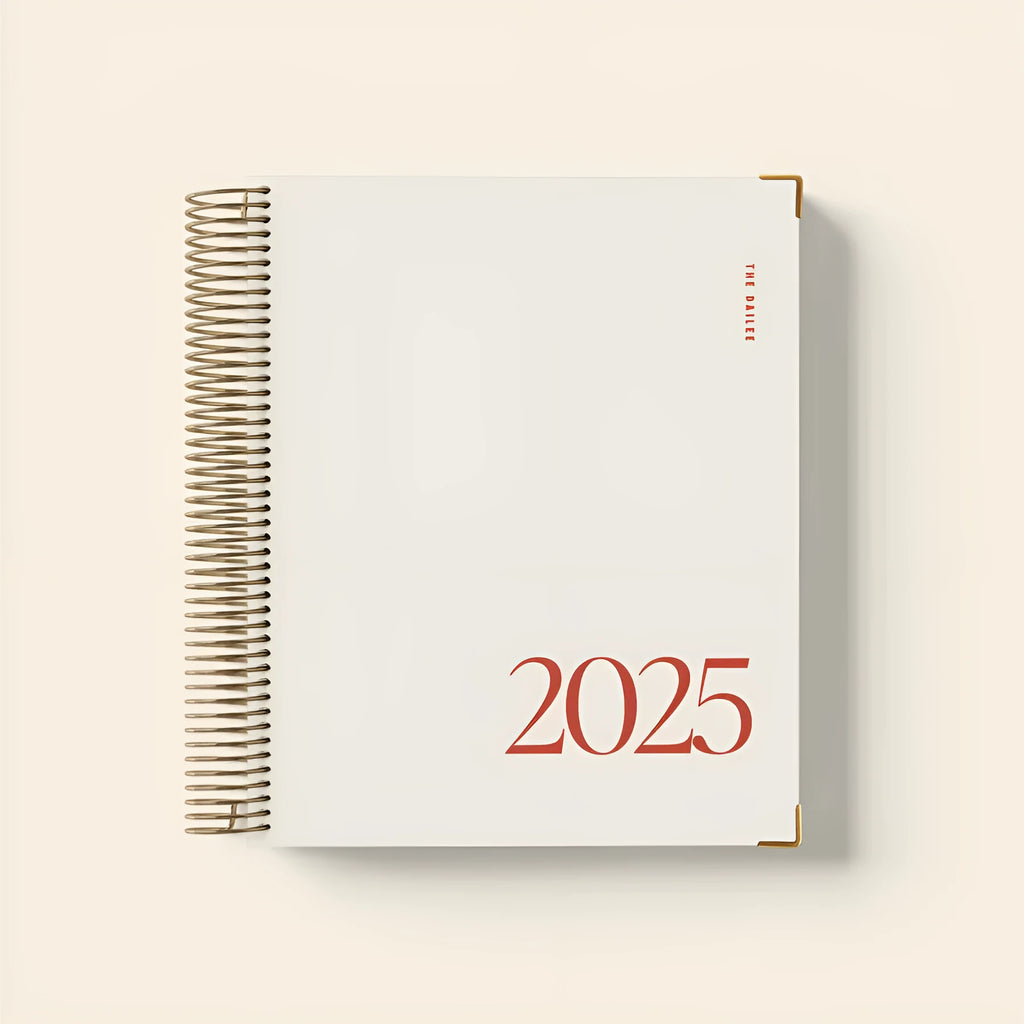 Cherry red coil-bound notebook open on desk showing flat-lying pages for comfortable writing