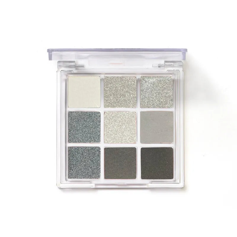 Open compact case showing nine powder eye shadow pans in neutral and smoky shades.