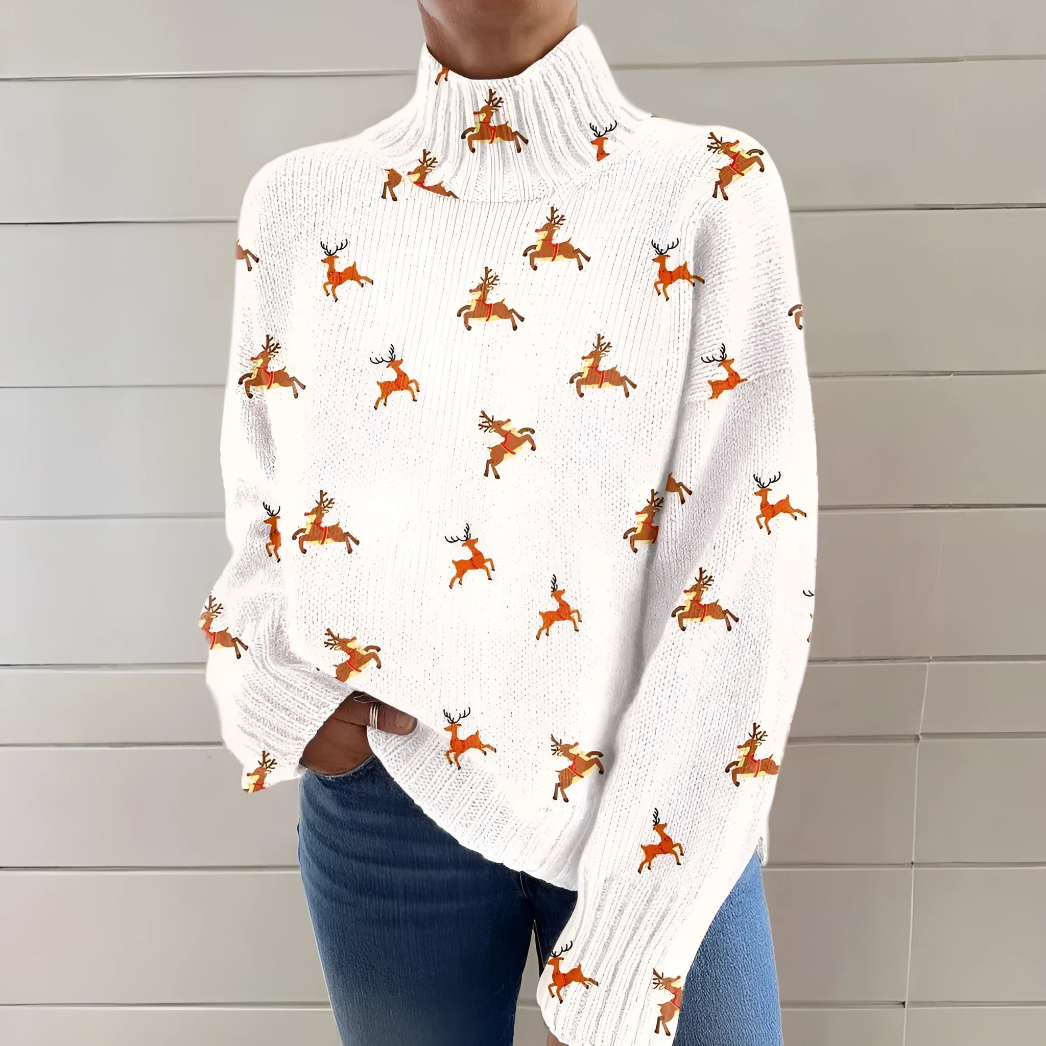 A woman's loose-fit Christmas sweater with a painted festive print, a turtleneck, and long sleeves in a soft macaron colour.