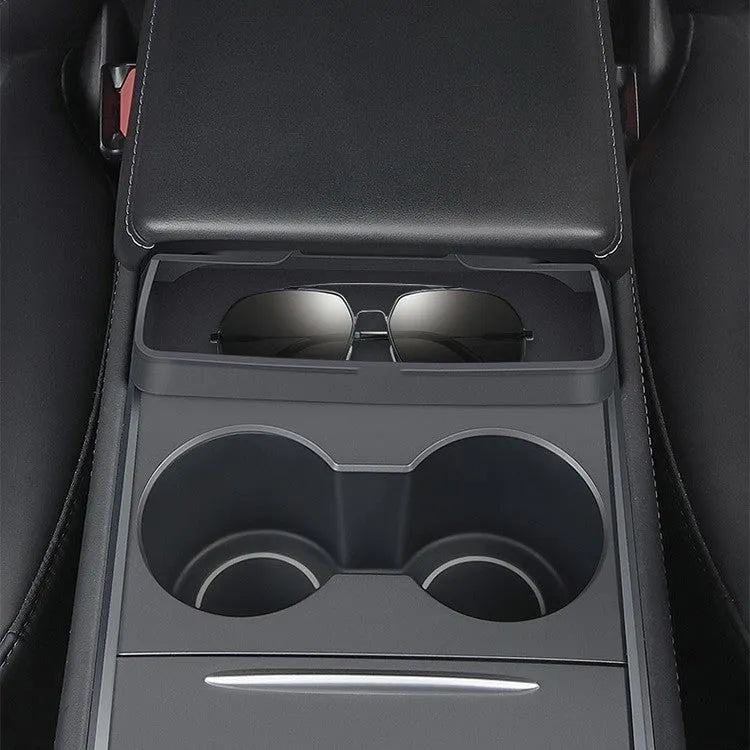 Black silicone glasses case installed inside a Tesla Model 3 or Y centre console armrest.