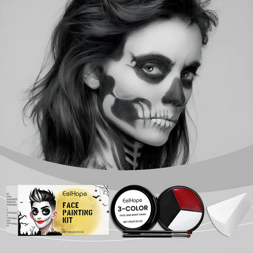 Halloween face painting kit with three colour concealer disc, two brushes, and one sponge on a flat surface
