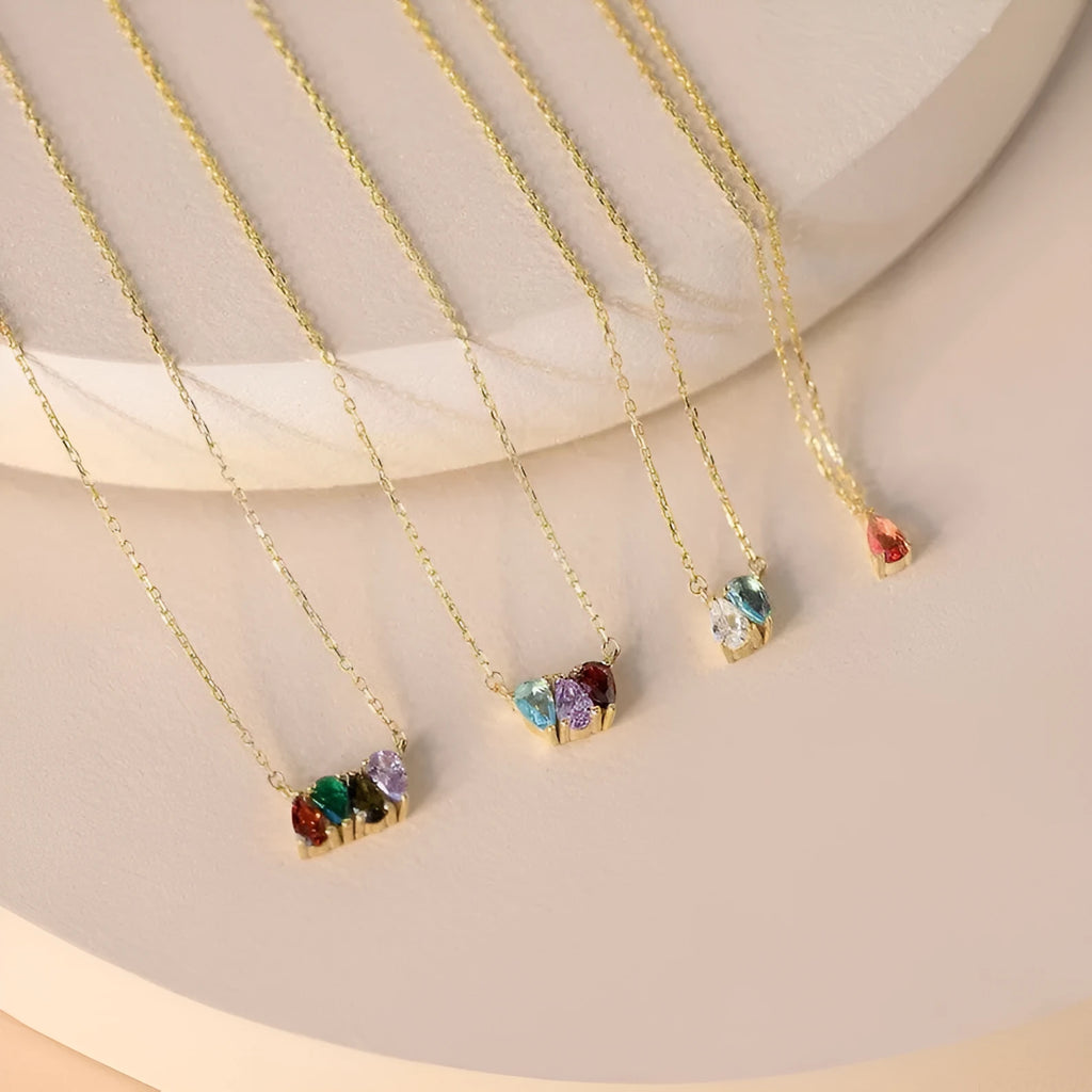 Zircon gemstone clavicle chain necklace in titanium steel, shown in gold, rose gold, and silver finishes.