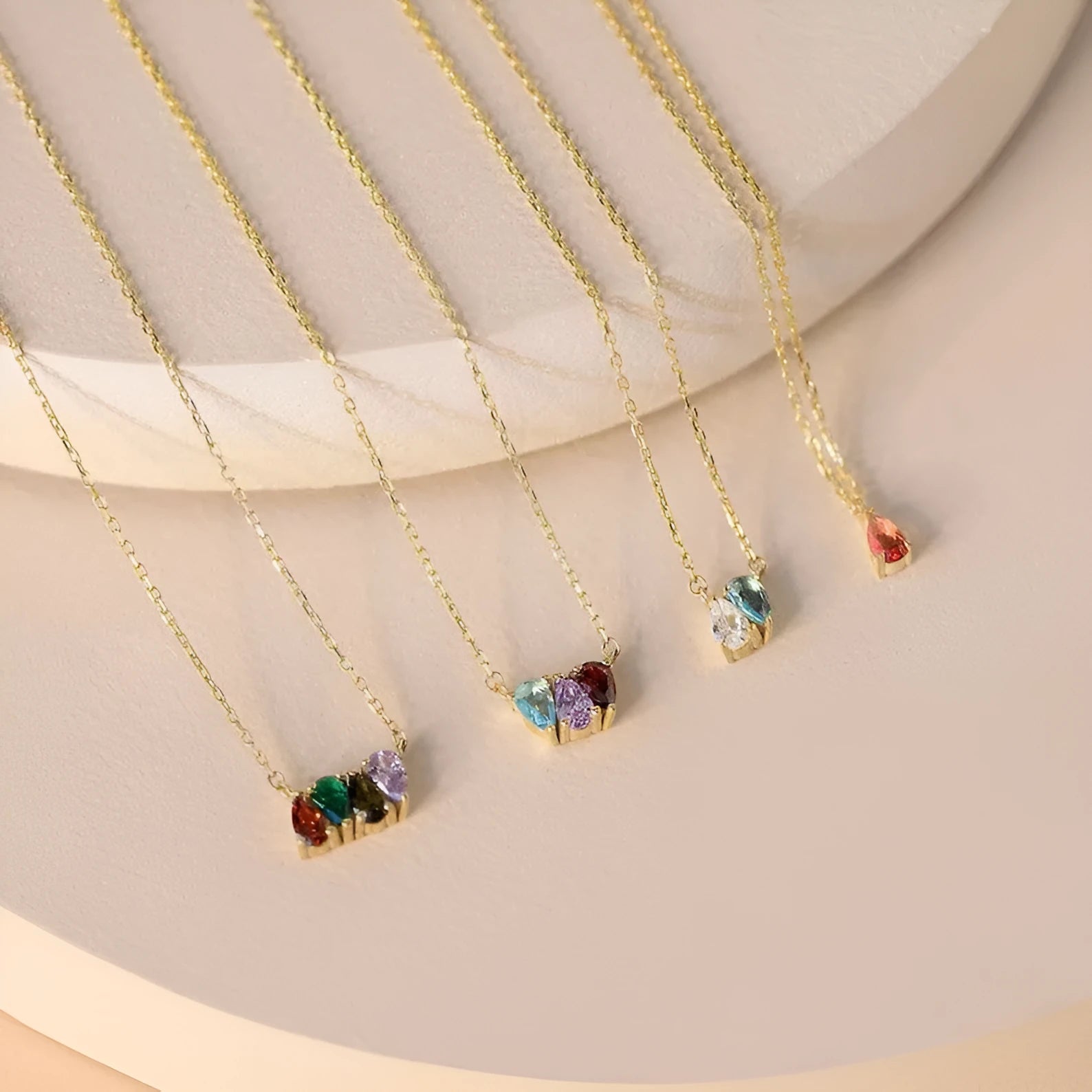 Zircon gemstone clavicle chain necklace in titanium steel, shown in gold, rose gold, and silver finishes.