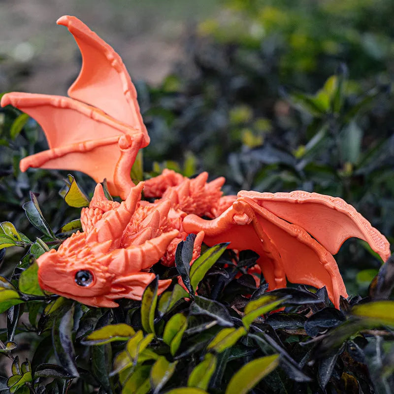 Red and gold PLA flying dragon wings decoration toy measuring 25cm wide.