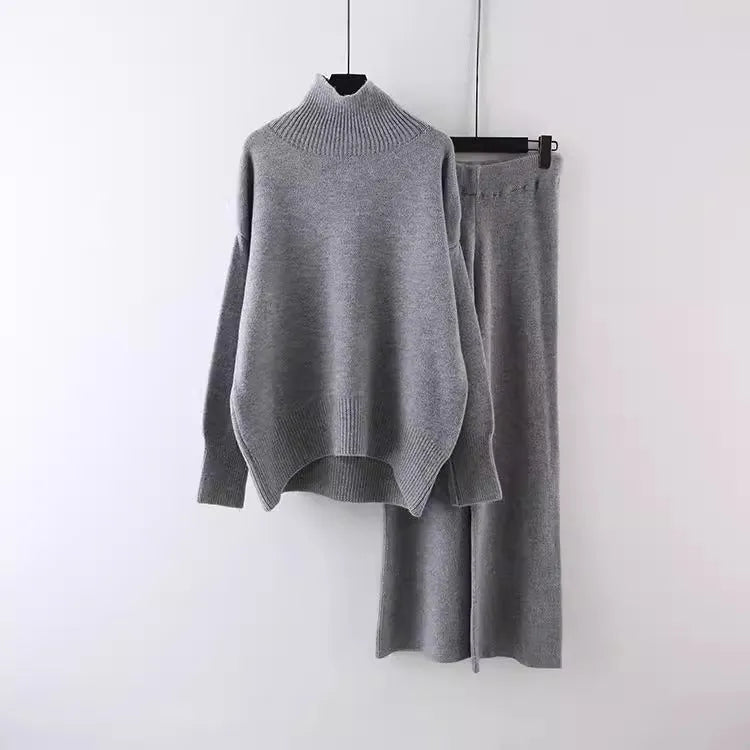 Women's beige acrylic knit sweater and wide-leg trousers two-piece set laid flat.
