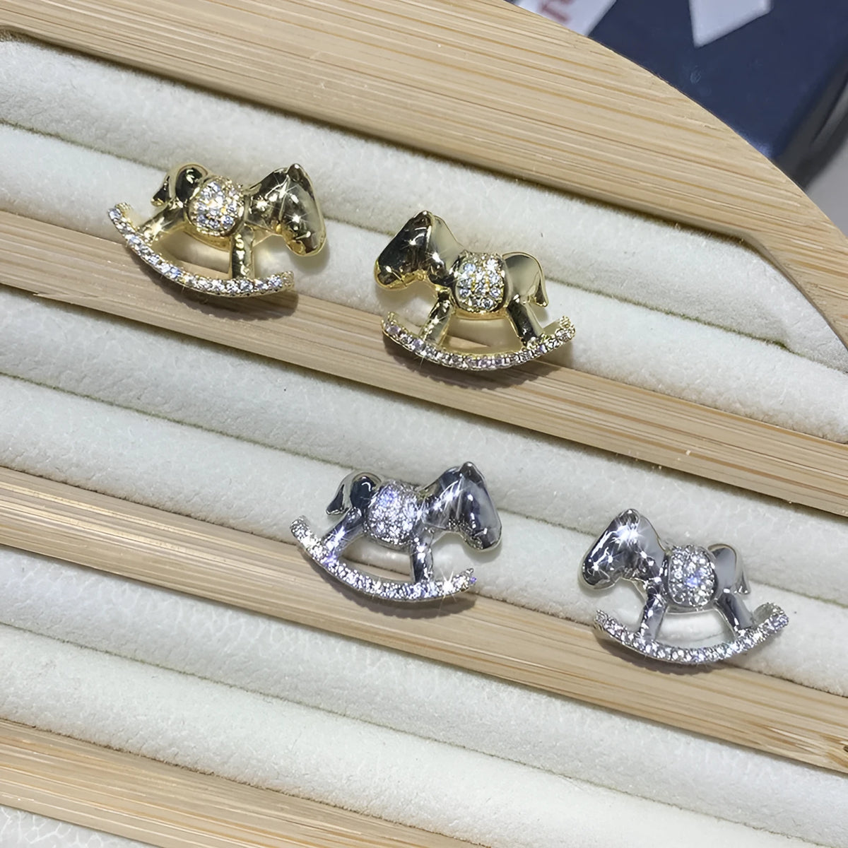 Diamond studded rocking horse earrings in gold and silvery metal finish for women
