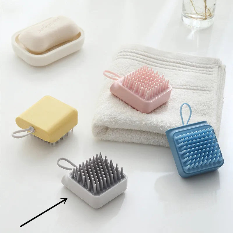 Pet bath brush with soft TPR combs for dog and cat grooming, available in blue, pink, white, and yellow.