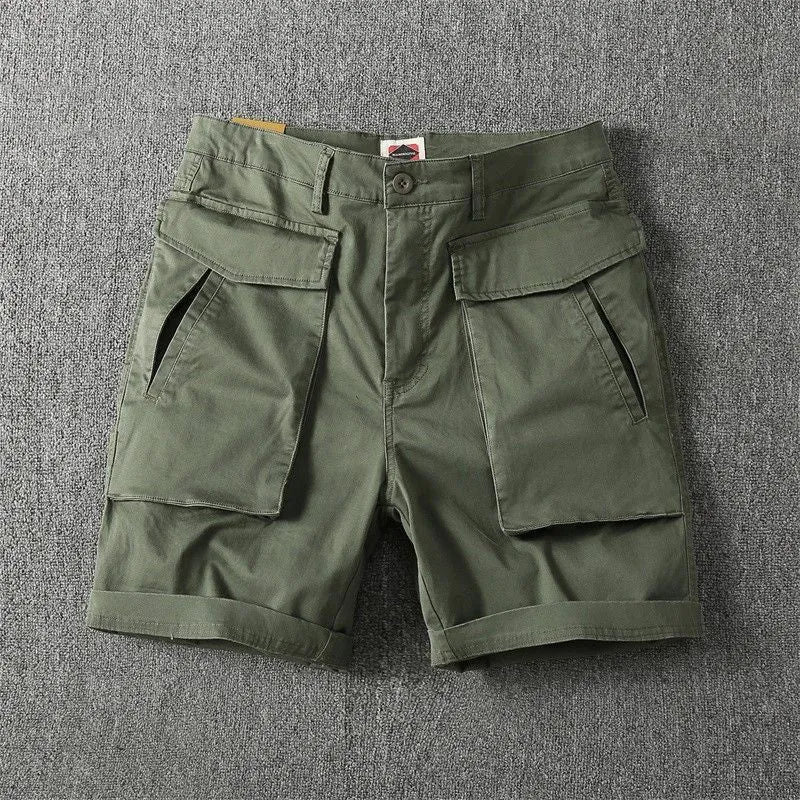 Men's straight-leg cotton cargo shorts in khaki with multiple pockets, shown on a model.