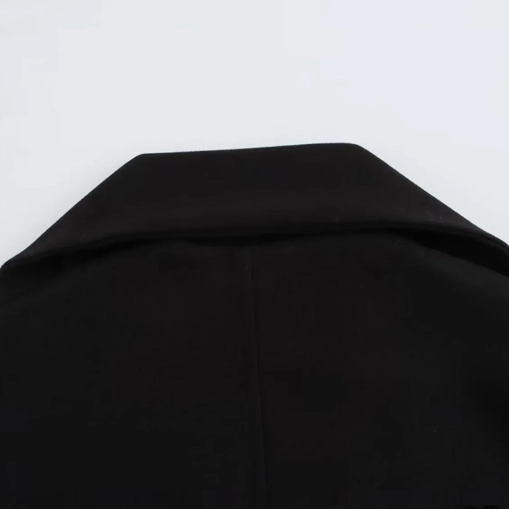 Women's long black polyester overcoat with a fluffy artificial fur collar, shown on a hanger.