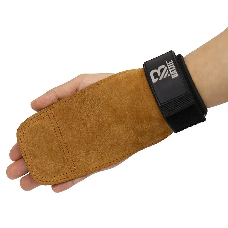 A pair of brown full-grain leather wrist support bands with hook-and-loop fasteners, laid flat.