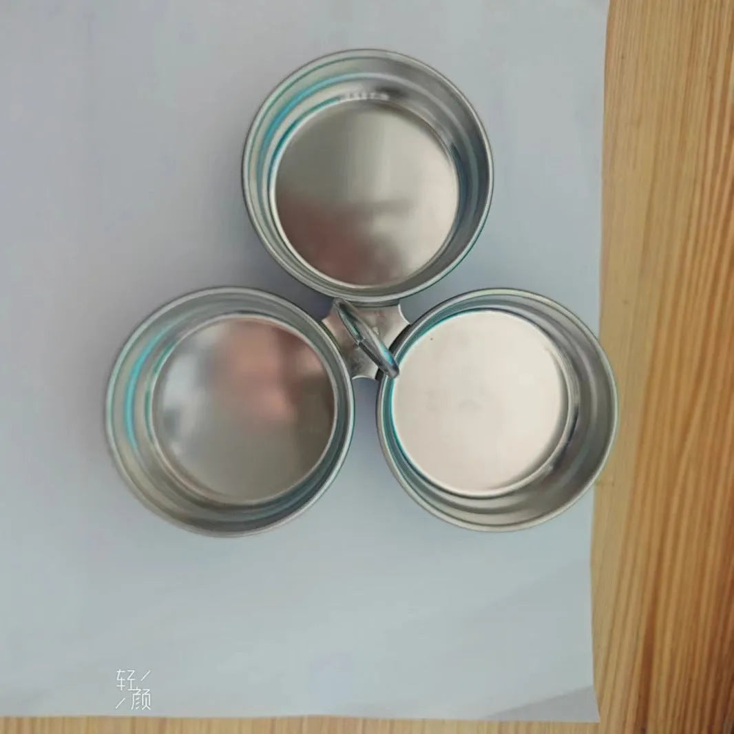 A small, round, heart-shaped stainless steel egg steamer for stovetop use.