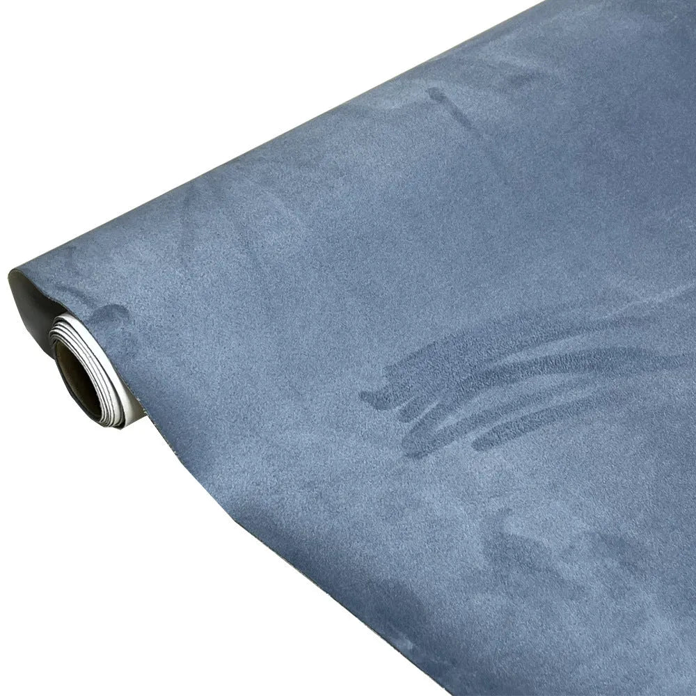 Roll of self-adhesive leather suede fabric in BMW brown colour next to a car dashboard.
