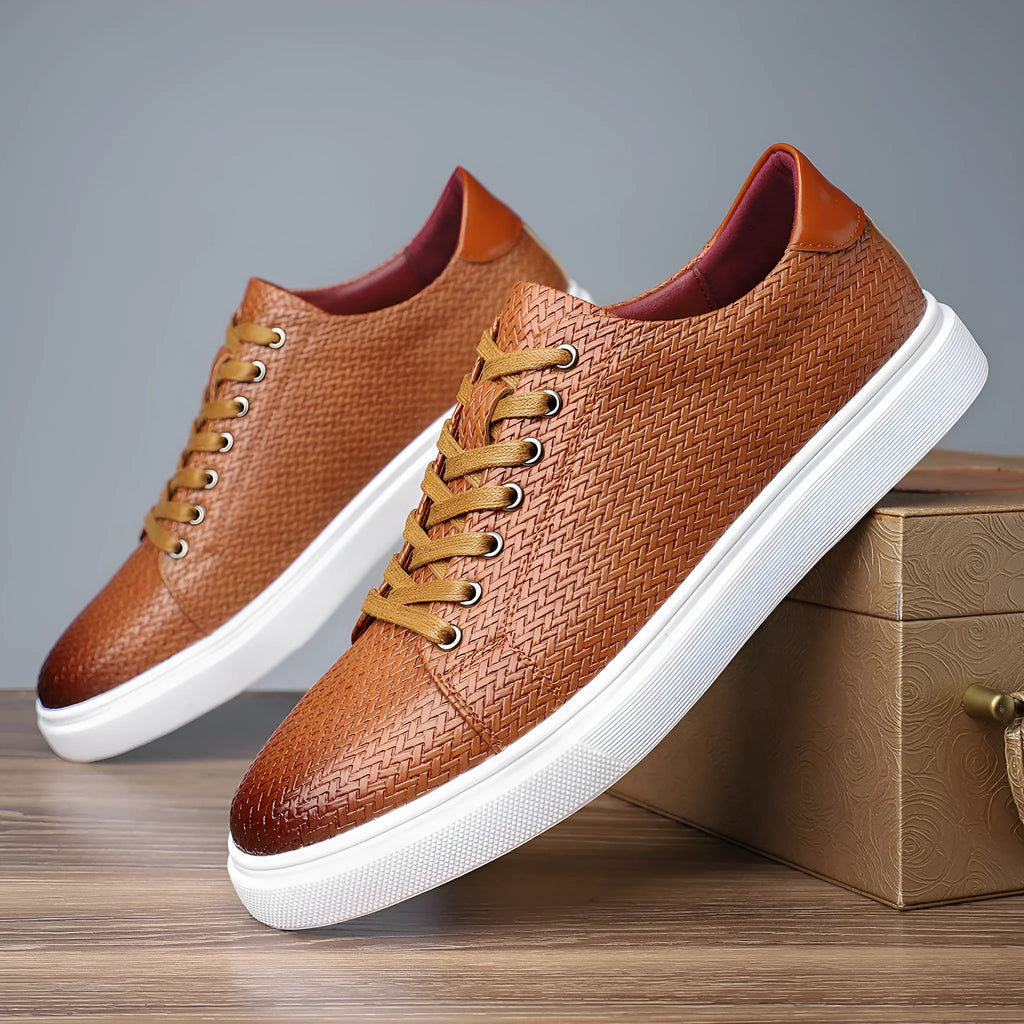 Men's low-top black leather-style shoes with decorative stitching and a rubber sole.