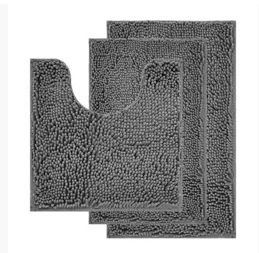 Dark green chenille U-shaped toilet mat with two matching rectangular bathroom mats on a tiled floor.