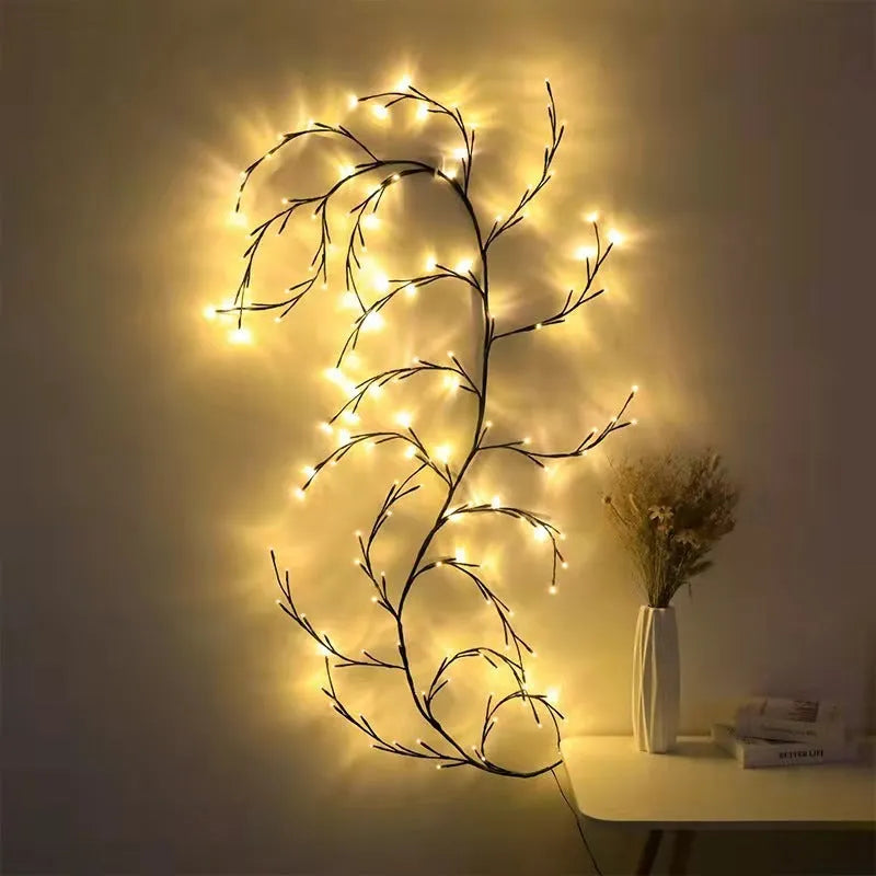 Flexible plastic willow vine LED garland light with warm white bulbs and birch bark texture.