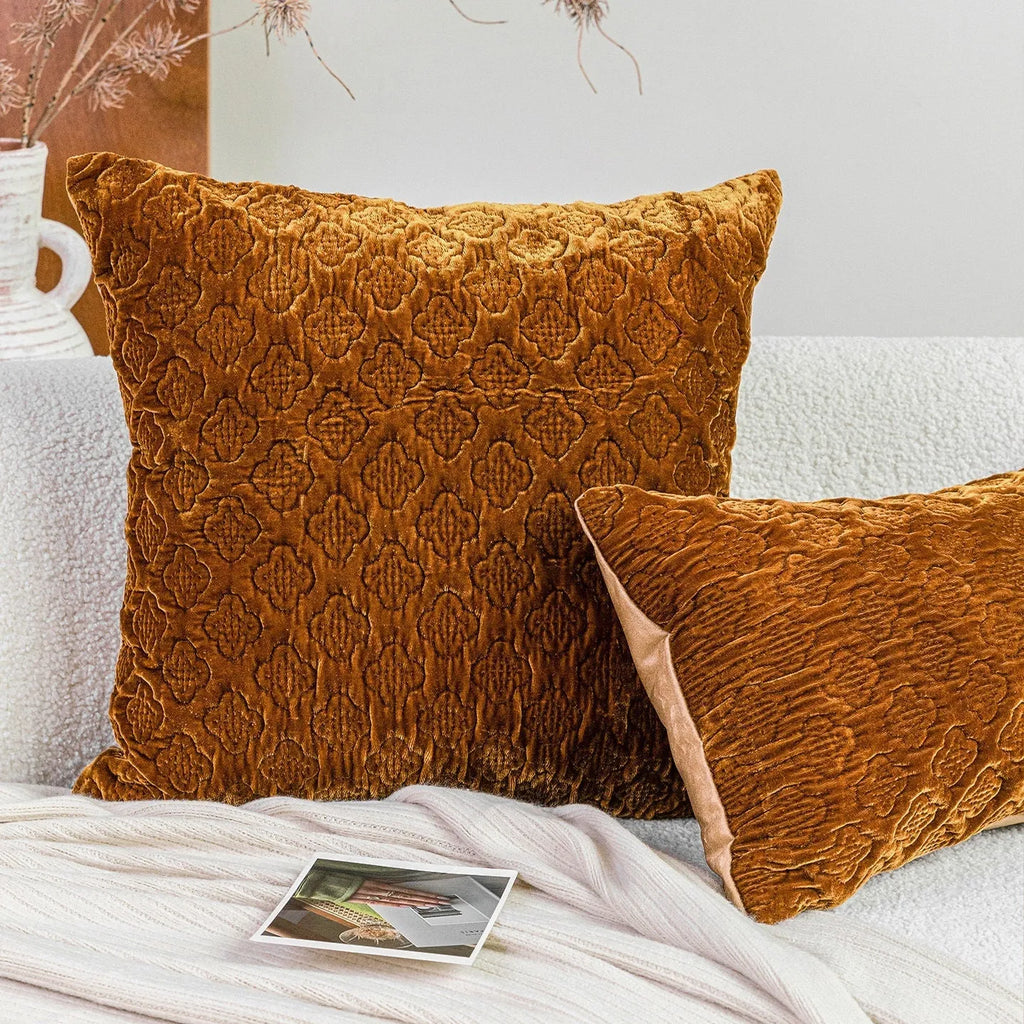 Brown gold antique style quilted square cushion with three-dimensional texture on a sofa.