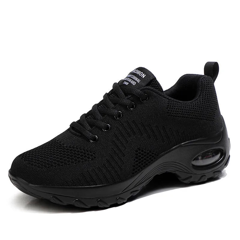 Women's low-top black mesh sneakers with white laces and a 3-5cm heel on a grey background.