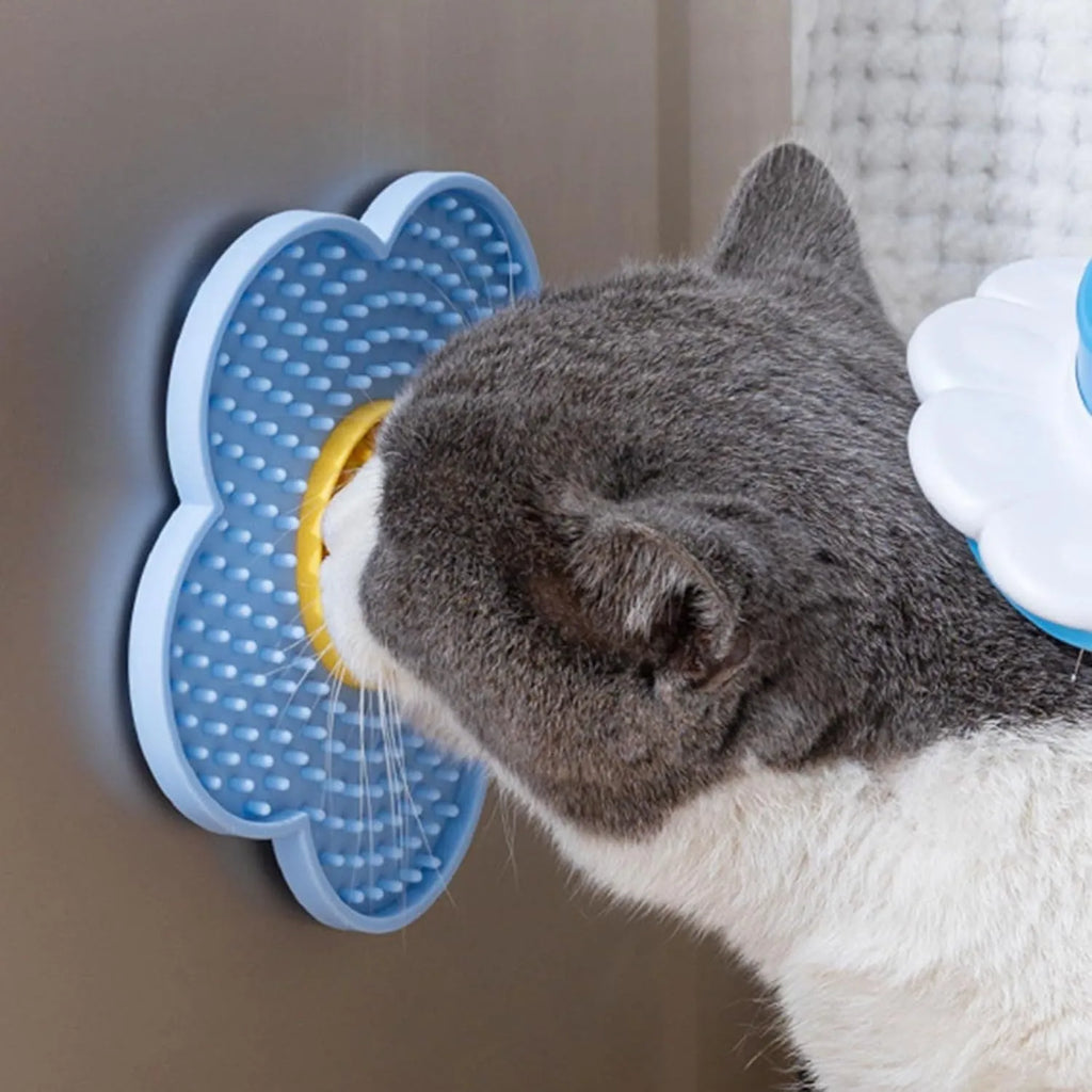 Flower-shaped silicone lick mat for dogs and cats with suction cups on a blue background.