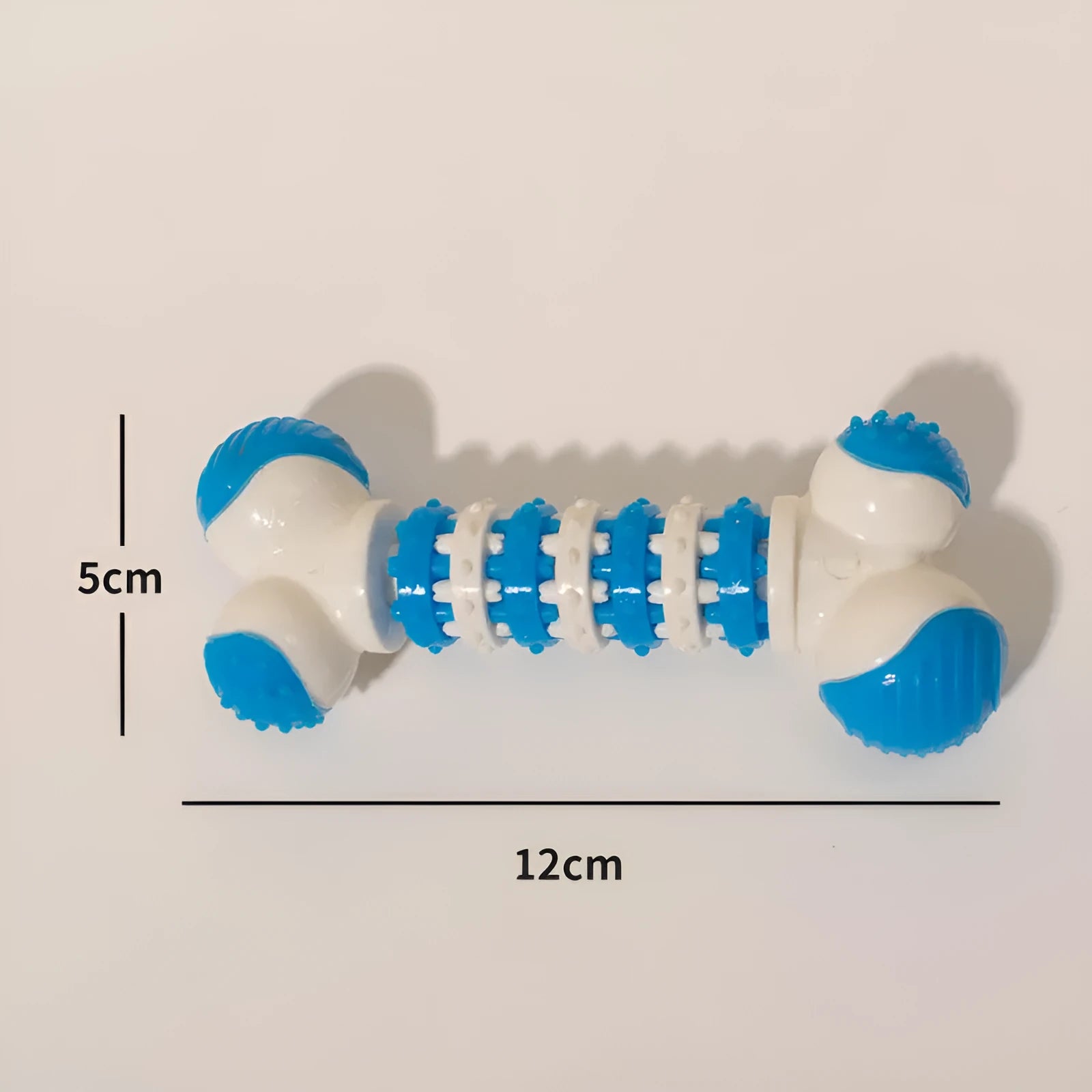 Blue bone-shaped rubber dog toy with a treat holder in the centre, shown next to dog biscuits.