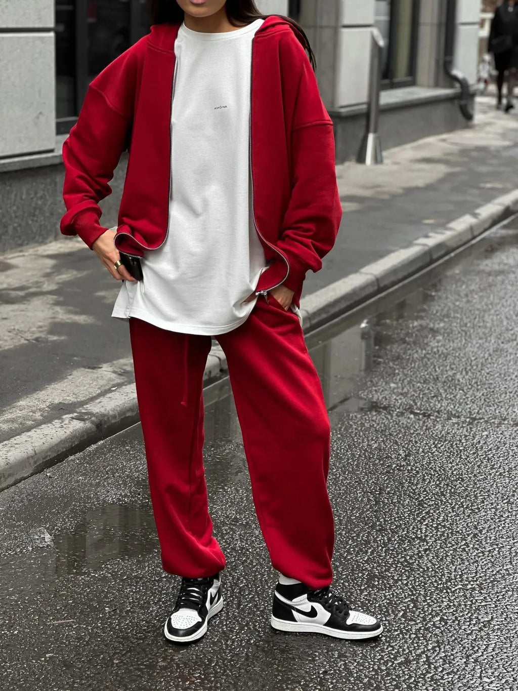 Red loose-fit street style two-piece set with long-sleeved coat and trousers on a model.