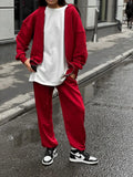 Red loose-fit street style two-piece set with long-sleeved coat and trousers on a model.
