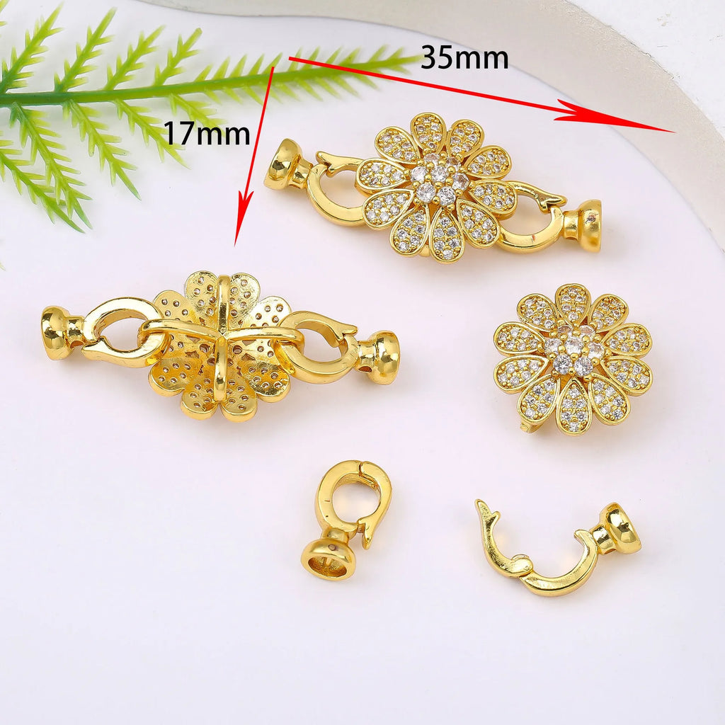 Small gold-colour electroplated metal jewellery buckle clasp on a white background.