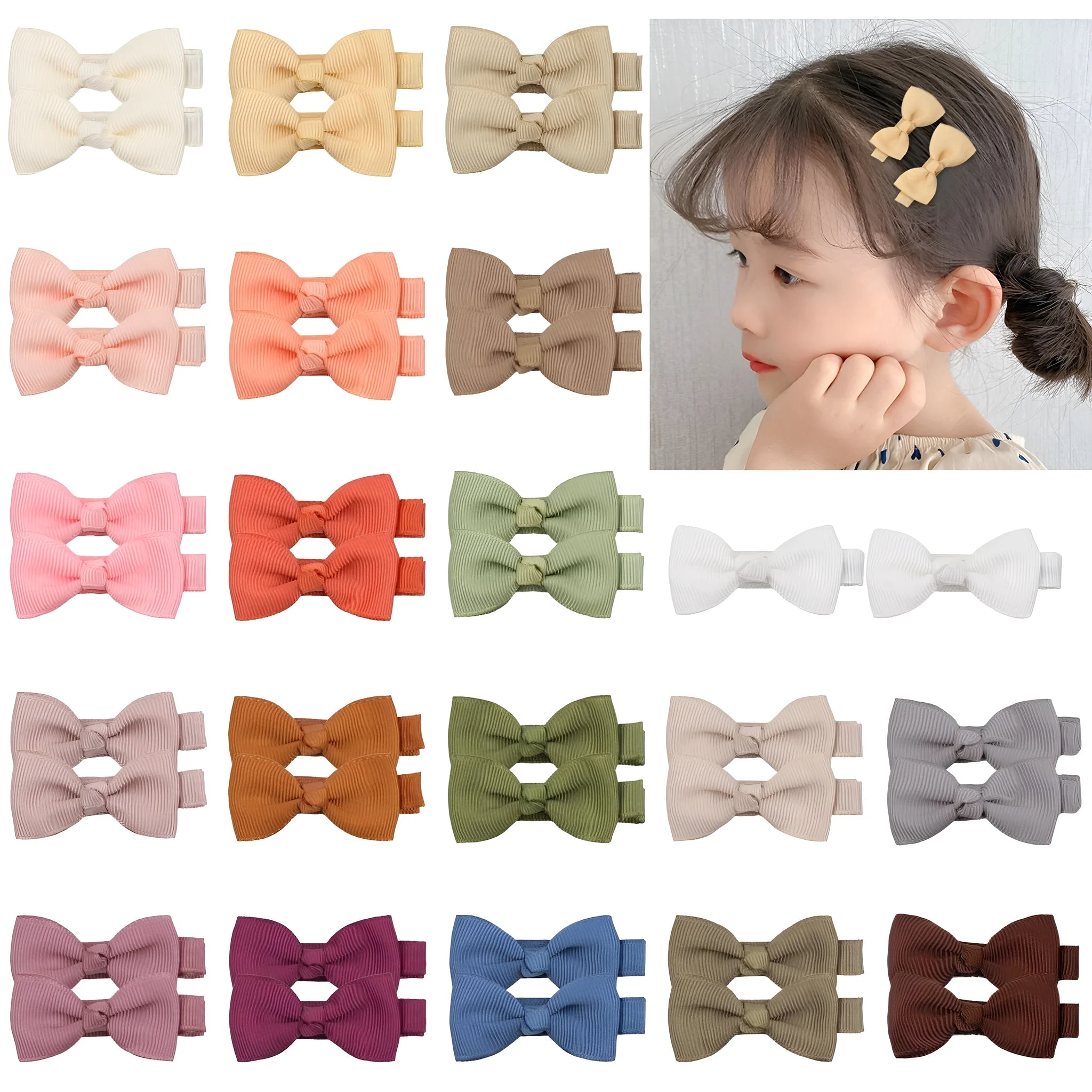 Assortment of pastel-coloured barrette and bow hair clips for babies and toddlers on a white background.