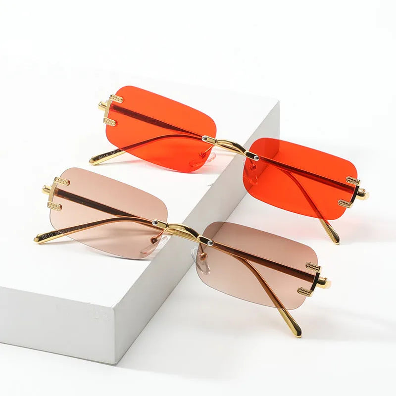 Retro square frameless sunglasses with gold metal frame and black/gray AC lenses