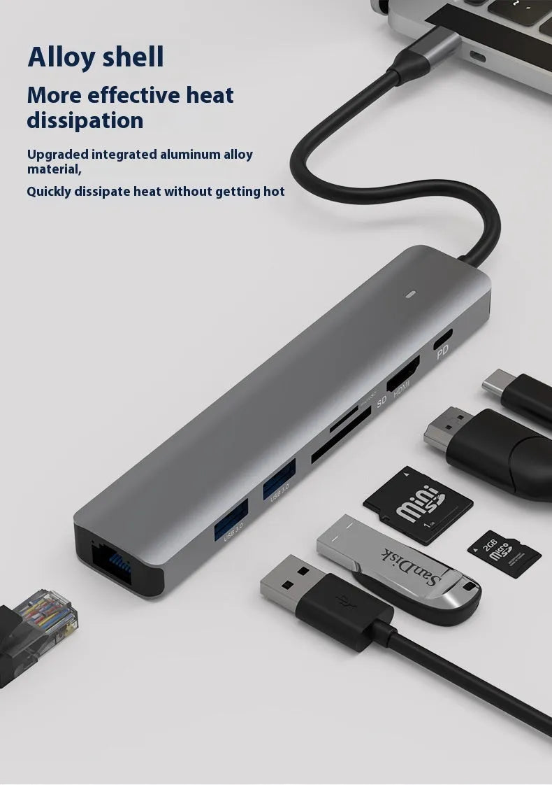 LQT-LH07 7-in-1 card reader and USB-C PD computer hub on a desk next to a laptop.