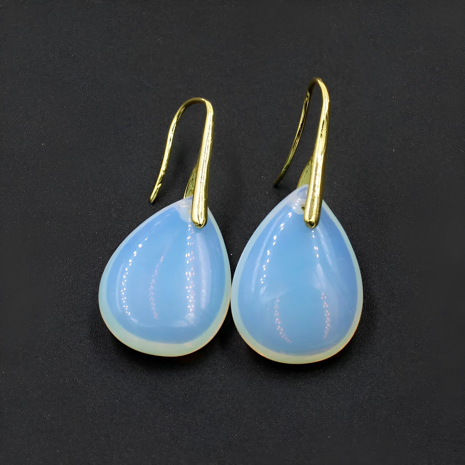 Geometric water drop earrings featuring a green aventurine crystal in a silver-toned electroplated setting.