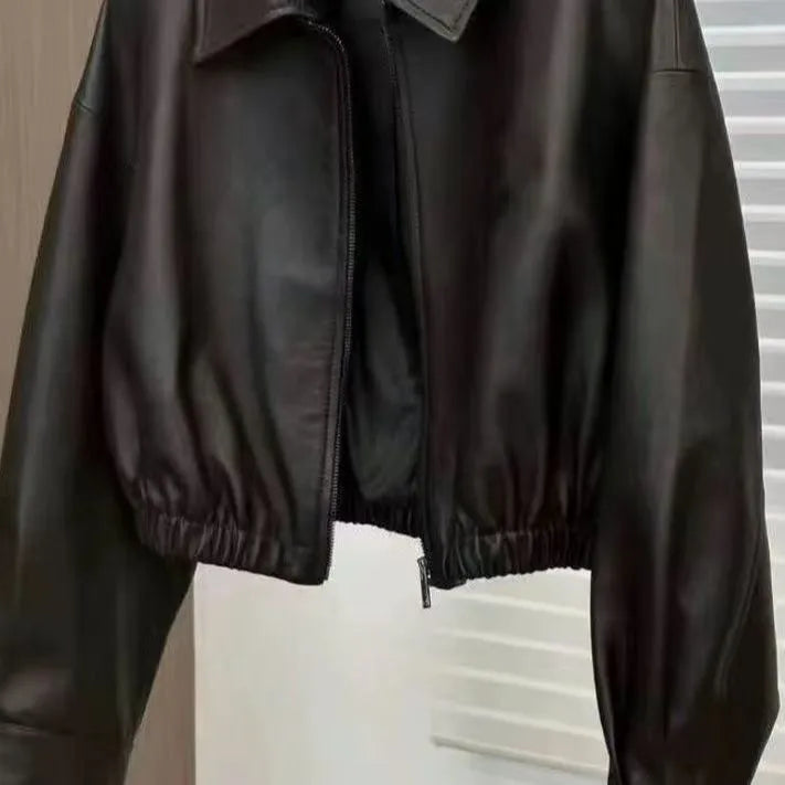 Women's black faux leather square-neck zip jacket with princess sleeves and washed finish on a model