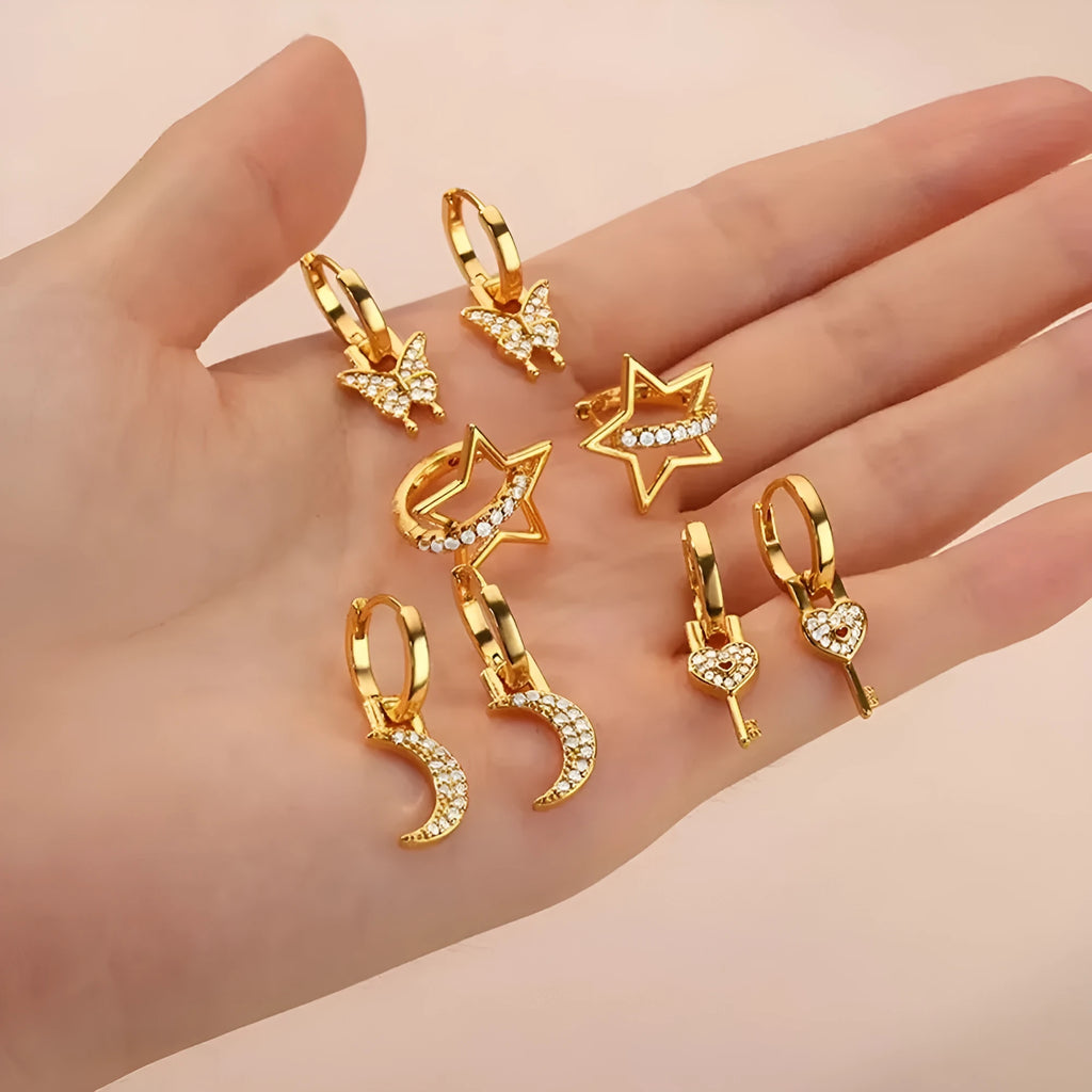 Women's geometric butterfly-shaped copper earrings with heart and star details in various colours.
