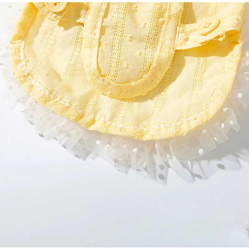 Two-tone sleeveless pet outfit in yellow or blue with ruffles, matching bow and small woven crossbody bag.