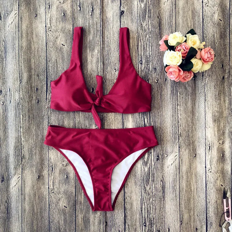 Women's solid colour bikini set showing bra top and briefs in black, pink, red, white, or wine red.