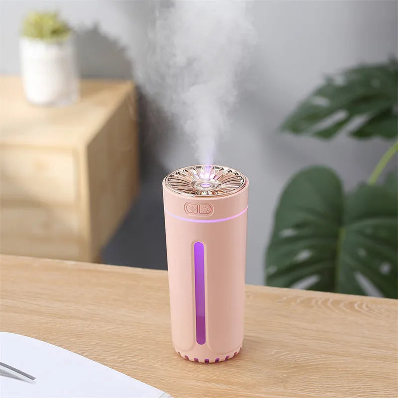 Black portable USB rechargeable humidifier with colourful lights on a car cup holder.