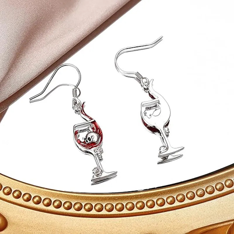 A pair of zinc alloy electroplated earrings depicting a skull inside a wine glass shape.