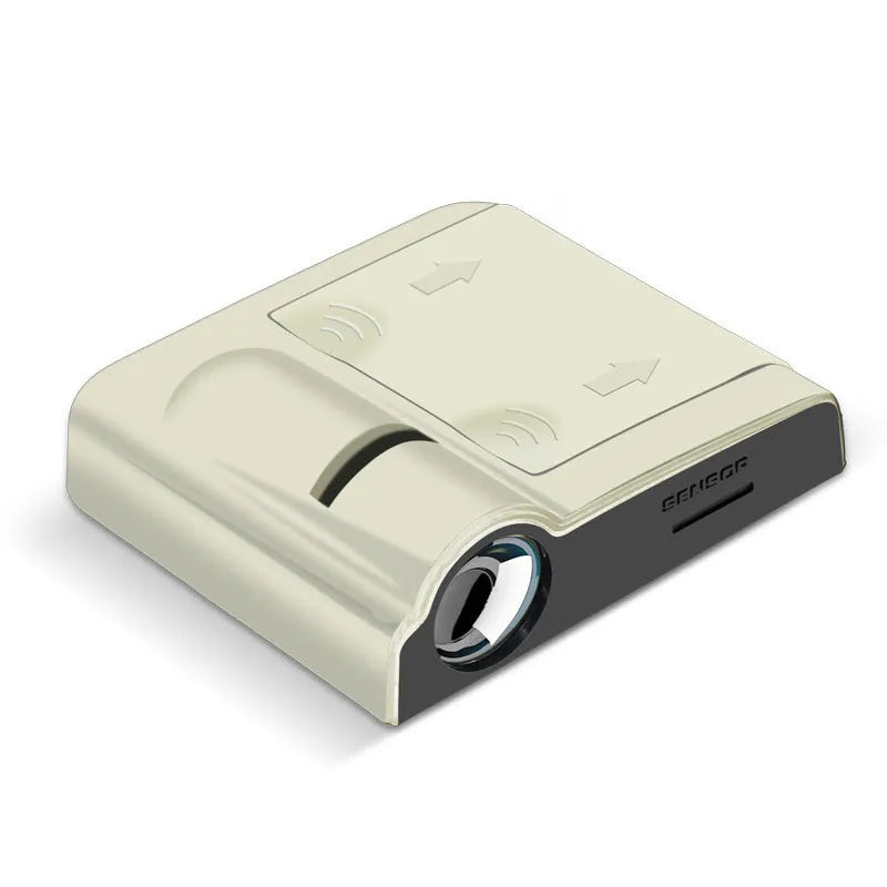 Small black car projection lamp showing front design and battery compartment, next to AA batteries for scale.