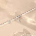 Close-up of a women's silver bracelet with a detailed pearl snake design, shown in both gold and white gold colour options.