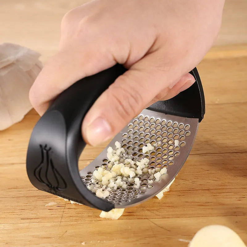 Stainless steel garlic press with polypropylene handles in modern design