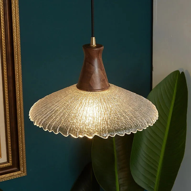 Brass-toned wood and glass chandelier with a retro design for ceiling mounting.