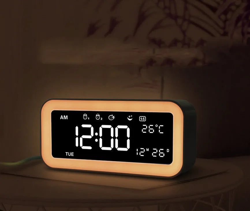 Rectangular blue and pink multifunctional LED atmosphere alarm clock with digital display and quartz glass mirror.